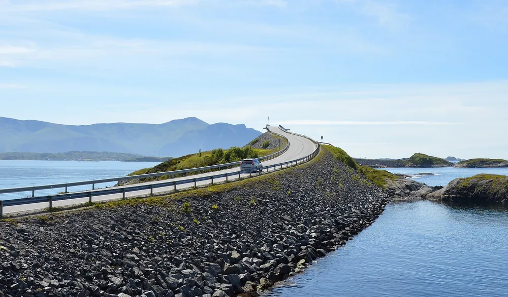 Low angle view of Storseisundet Bridge over rocky shore, Norway