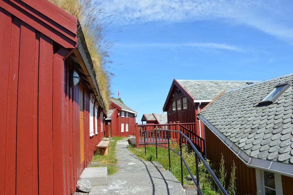 Traditional red wooden buildings with grass roofs on Håholmen island